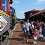 Tourists arrive at the historic Elkins passenger station, a gateway to the Monongahela National Forest and one of the communities participating in the Mon Forest Towns partnership. A new West Virginia University study is helping rural destinations balance tourism growth with the needs of local residents.