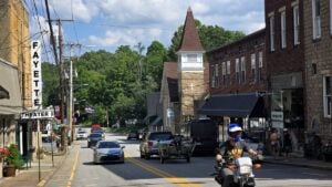 Visitors stroll Fayetteville's historic downtown on a summer afternoon, where locally owned shops, restaurants, and the iconic Fayette Theater help make the New River Gorge gateway town one of West Virginia's most popular destinations. (Photo: David Sibray)