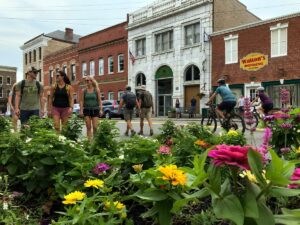 Outdoor enthusiasts stroll and cycle through downtown Fayetteville, where historic storefronts, locally owned businesses, and easy access to the New River Gorge have made the town one of West Virginia's most popular travel destinations.