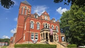 The Fayette County Courthouse occupies the hill where Union forces constructed Fort Scammon during the Civil War. On May 19, 1863, Confederate artilleryman Milton W. Humphreys fired on the fort from behind a nearby wooded ridge, pioneering the first documented use of indirect artillery fire in modern warfare.