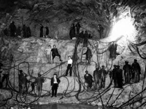 Workers pose inside the Hawk's Nest Tunnel during construction near Gauley Bridge, W.Va., in the early 1930s. Many laborers were exposed to dangerous silica dust while drilling through nearly pure quartz rock, leading to one of the deadliest industrial disasters in American history.