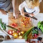 Mood Food: A family prepares a meal featuring leafy greens, berries and other nutrient-rich foods. West Virginia University nutrition experts say diets rich in omega-3 fatty acids, antioxidants and other whole foods may help support emotional well-being while reducing inflammation. (Getty Image)