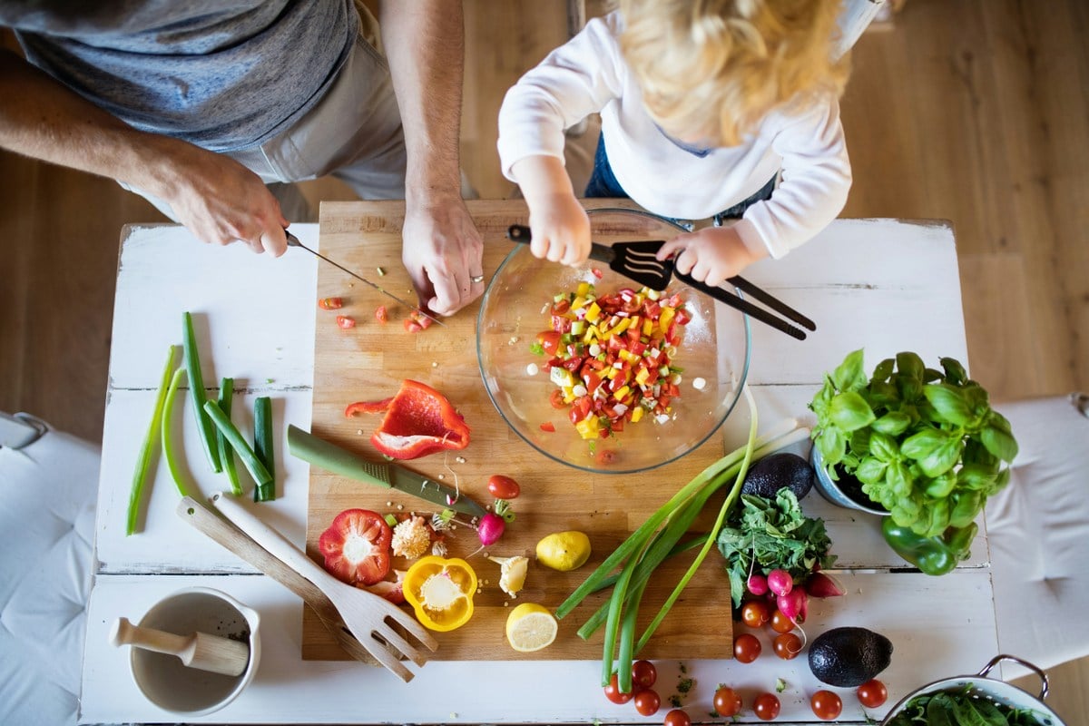Mood Food: A family prepares a meal featuring leafy greens, berries and other nutrient-rich foods. West Virginia University nutrition experts say diets rich in omega-3 fatty acids, antioxidants and other whole foods may help support emotional well-being while reducing inflammation. (Getty Image)