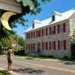 A tourist photographs a historic home in the Middleway National Historic District in West Virginia.