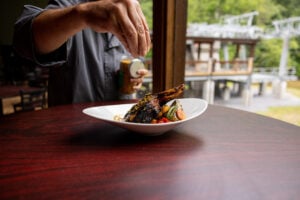 A chef spices a dish at Mountain Creek Appalachian Cuisine.