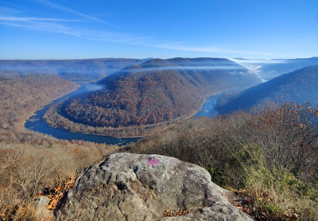 Smoke gathers above the New River Gorge National Park and Preserve during a wildfire. Researchers at West Virginia University are developing an artificial intelligence system that could help satellites detect and track wildfires more quickly across rugged, heavily forested landscapes.