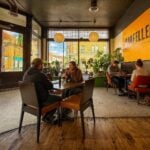 Diners gather inside Oddfellers in downtown Richwood, where locally sourced Appalachian ingredients and from-scratch cooking have helped make the restaurant a destination for visitors exploring the surrounding mountains, trout streams, and hiking trails.