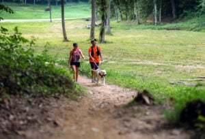 A couple walks their dog along a Putnam County trail. Local officials say growing interest in hiking, walking and other outdoor recreation is helping reshape the county into an emerging destination for active living and nature-based tourism.