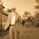 Rev. Dyke Garrett, the mountain preacher who rode horseback through the rugged hills of southwestern West Virginia for more than 50 years, ministers to a gathering of Appalachian families. Garrett became one of the few trusted figures among both the Hatfield and McCoy families during the infamous feud.