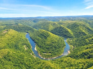 Viewed from above, Stretcher Neck forms one of the most dramatic landforms in the New River Gorge. Much of the surrounding landscape has been acquired by the Arc of Appalachia, protecting nearly 2,000 acres adjoining New River Gorge National Park and Preserve while helping pave the way for a future trail connection between Beckley and the park. (Photo: Lori Herrald Lebl)