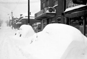 Snow buries homes and businesses during the Thanksgiving Blizzard of 1950, part of the Great Appalachian Storm that struck 22 states across the eastern United States. The record-setting storm left hundreds dead nationwide and remains one of the most destructive winter storms in American history, with West Virginia among its hardest-hit states.