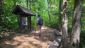 A hiker reviews trail information before setting out through the wooded trails at Walter Nature Preserve in Putnam County, West Virginia.