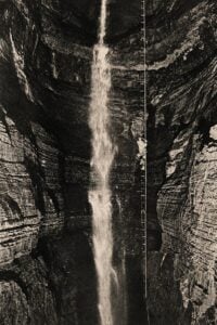 An early cave explorer descends a ladder into the immense depths of Cass Cave in West Virginia. Historian Charles Carpenter reproduced the dramatic image in his writings on West Virginia caves and the lore associated with them.