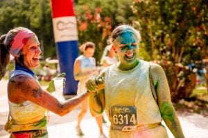 Participants celebrate after being covered in colored powder during a previous Color Dash for Hope at ACE Adventure Resort near Oak Hill, West Virginia. The annual 5K raises money for recovery and healing efforts across Appalachia. Photo courtesy ACE Adventure Resort.