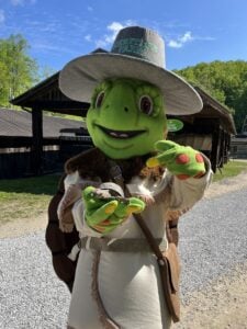 Wilder, the turtle mascot at Heritage Farm Museum and Village near Huntington, greets young visitors exploring one of West Virginia's most family-friendly attractions. The pioneer-inspired character reflects the museum's mission of making Appalachian history engaging for children and families. (Photo courtesy Heritage Farm)