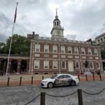 A vehicle promoting Berkeley Springs, West Virginia, passes Independence Hall in Philadelphia as part of a 12-week tourism campaign connecting the spa town's 250th anniversary with the nation's semiquincentennial. Photo courtesy Travel Berkeley Springs.