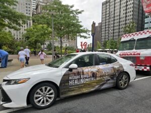 A rideshare vehicle wrapped with Berkeley Springs tourism advertising passes LOVE Park in Philadelphia as part of a 12-week, $36,000 campaign promoting the West Virginia spa town during its 250th anniversary. Photo courtesy Travel Berkeley Springs.