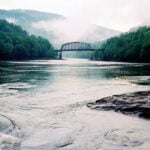 The New River winds through a landscape where railroads, communities, industrial history and outdoor recreation remain intertwined inside New River Gorge National Park and Preserve.