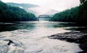 The New River winds through a landscape where railroads, communities, industrial history and outdoor recreation remain intertwined inside New River Gorge National Park and Preserve.