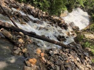 Floodwaters surge through rocks in New River Gorge National Park and Preserve following torrential rainfall Sunday. Park officials warned visitors to remain vigilant, particularly around streams and low-lying areas, with additional rain expected overnight. (NPS photo)