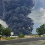 A massive plume of black smoke rises from the Peoples Cartage warehouse fire in Parkersburg on July 5, 2026. The fire prompted extensive environmental testing of water, soil and agricultural products in the surrounding area. (Photo by Dan Fauxsmith/CC BY-SA 4.0)