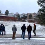 Developers and project representatives examine the site of the planned TAProom development on Spruce Street in Thomas, West Virginia. The $4.3 million project will add workforce housing and commercial space downtown. (Photo courtesy Woodlands Development & Lending)
