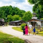 Visitors stroll through the recreated 19th-century village at Heritage Farm Museum and Village near Huntington, West Virginia, the state's only Smithsonian Institution Affiliate. The 150-acre destination combines Appalachian history, artisan demonstrations, wildlife and outdoor adventure.