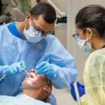 Students train at the West Virginia University School of Dentistry in Morgantown. WVU operates the state's only dental school and says more than 85% of dentists practicing in West Virginia are graduates of the school. (WVU Photo)