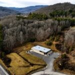 An aerial view of Wood Mountain rises above U.S. 19 near Glen Jean in Fayette County. For decades, residents have reported unexplained lights over the forested ridge, making it one of southern West Virginia's lesser-known folklore mysteries.