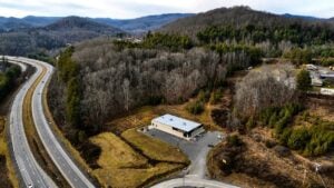 An aerial view of Wood Mountain rises above U.S. 19 near Glen Jean in Fayette County. For decades, residents have reported unexplained lights over the forested ridge, making it one of southern West Virginia's lesser-known folklore mysteries.