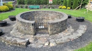 The Janutolo Well stands in a small park at Keller Avenue and North Court Street in Fayetteville, West Virginia. An open well occupied the site by the Civil War era, and the present stonework dates to the early 20th century. (WVExplorer.com photo)