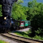 A steam-powered excursion train travels through the mountains at Cass Scenic Railroad State Park in Pocahontas County, West Virginia. A new 100-site campground has opened at the popular railroad and outdoor recreation destination.