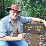 WVExplorer.com publisher and historian David Sibray pauses at Beaver Creek Trail in southern West Virginia. Place names across the state often draw on streams, landforms, plants, animals, people and events that helped residents describe and distinguish the landscape.