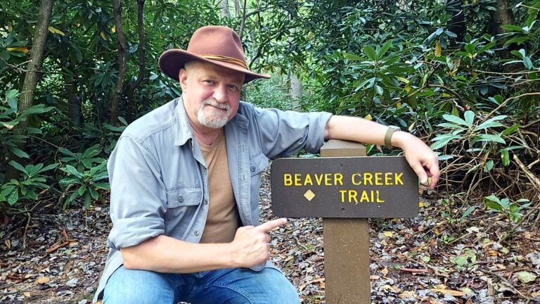 WVExplorer.com publisher and historian David Sibray pauses at Beaver Creek Trail in southern West Virginia. Place names across the state often draw on streams, landforms, plants, animals, people and events that helped residents describe and distinguish the landscape.