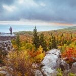 A hiker overlooks fall color from the high-elevation landscape of Dolly Sods Wilderness in eastern West Virginia. The region is among the first areas of the state to show autumn color. (Photo courtesy West Virginia Department of Tourism)
