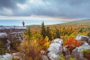 A hiker overlooks fall color from the high-elevation landscape of Dolly Sods Wilderness in eastern West Virginia. The region is among the first areas of the state to show autumn color. (Photo courtesy West Virginia Department of Tourism)