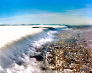 Fog spills over East River Mountain above Bluefield, West Virginia, in this 1993 photograph by Mel Grubb. At roughly 2,600 feet above sea level, Bluefield is one of West Virginia’s highest communities, where elevation and surrounding mountain terrain can produce dramatic fog, clouds, and rapidly changing weather.