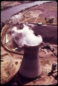 A coal stockpile lies beside a cooling tower at the John E. Amos Power Plant along the Kanawha River in West Virginia. Proposed state rules would require utilities to report monthly coal inventories, deliveries, consumption and fuel costs. (Harry Schaefer/U.S. Environmental Protection Agency, National Archives)