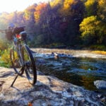 A bicycle rests beside the Meadow River along the Meadow River Rail Trail, an 18-mile route between Rainelle and Nallen in southern West Virginia. (Photo courtesy Meadow River Rail Trail)