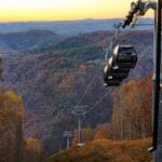 Pipestem Resort State Park’s aerial tramway descends into the Bluestone River Gorge amid autumn color. The park will host its first Oktoberfest Oct. 16–18, when fall foliage in the gorge typically approaches its seasonal peak. (Photo courtesy Perry Bennett Photography)
