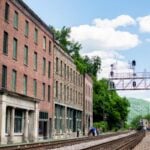 Historic buildings line the railroad at Thurmond, a former Chesapeake & Ohio Railway boomtown now largely preserved within New River Gorge National Park and Preserve. The town is challenging National Park Service plans to demolish several historic structures.