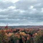 Low clouds spread across an Appalachian landscape in autumn. As summer fades, towering convective clouds become less common while broad layers of stratus and stratocumulus become more conspicuous during colder-season weather.
