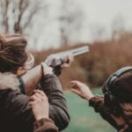 A young shooter receives guidance while handling a firearm. West Virginia has eliminated the minimum age for its special youth hunting seasons, although hunters younger than 15 must still be accompanied by a licensed adult. Photo credit: Remy Gieling