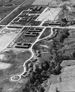 An aerial photograph shows staff housing, dormitories, parking areas, and administrative buildings at the West Virginia Ordnance Works near Point Pleasant, W.Va. The sprawling complex was built during World War II to manufacture TNT for the U.S. military.