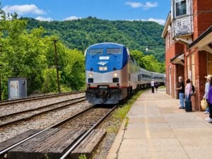 An Amtrak passenger train arrives at the historic railroad station in Hinton, West Virginia. The city's annual Railroad Days festival celebrates the railroad heritage that helped establish the community and continues to attract visitors to the southern New River Gorge.