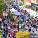 Visitors browse vendors during a previous Hinton Railroad Days celebration in downtown Hinton, W.Va. The annual festival continues October 9–11, 2026, without the dedicated excursion trains that once brought hundreds of passengers to the city.