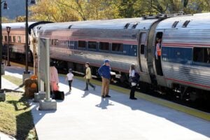 A New River Train excursion travels through southern West Virginia during the fall foliage season. The popular excursions helped establish Hinton Railroad Days as an annual tradition before the original service ended in 2018. 