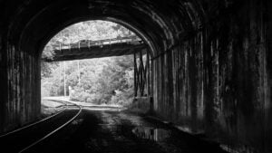 Railroad tracks curve through Stretcher's Neck Tunnel near Prince, West Virginia. The historic tunnel is associated with a ghost story involving a tragic love triangle, a legend reportedly recounted as early as the 1890s.