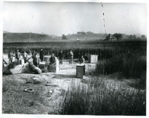 Workers with the Point Pleasant Nursery Company tend plants in the Ohio River lowlands near Point Pleasant, W.Va., in 1910 or 1911. The photograph documents the area's agricultural landscape decades before construction of the West Virginia Ordnance Works in 1942. (West Virginia & Regional History Center, West Virginia History OnView, image 017422)