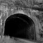 Stretcher's Neck Tunnel near Prince, West Virginia, is associated with a ghost story involving a tragic love triangle. The railroad legend is among several supernatural tales linked to the New River Gorge.
